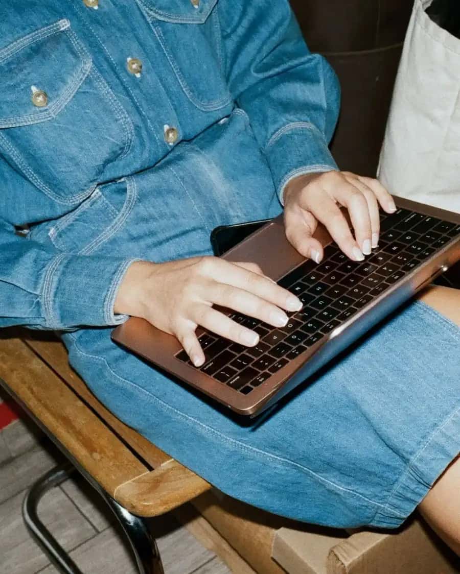 Person writing a personal email at a table
